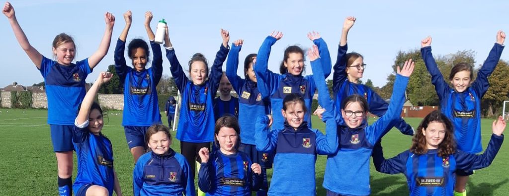 Rosemount Girls Team in a blue kit celebrating after official photo